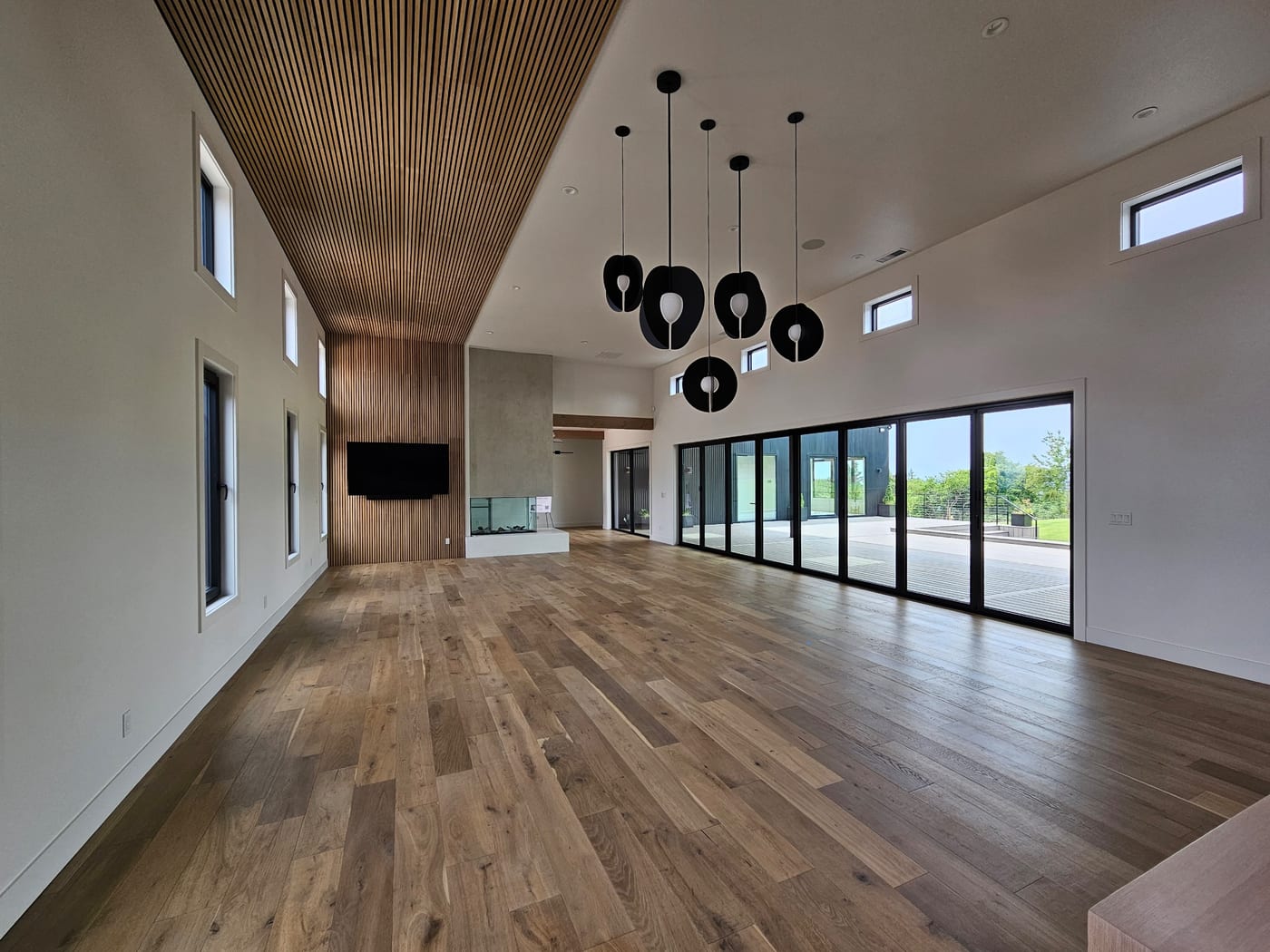 Wide-plank oak through an open plan by Artemidas Renovation, Loganville