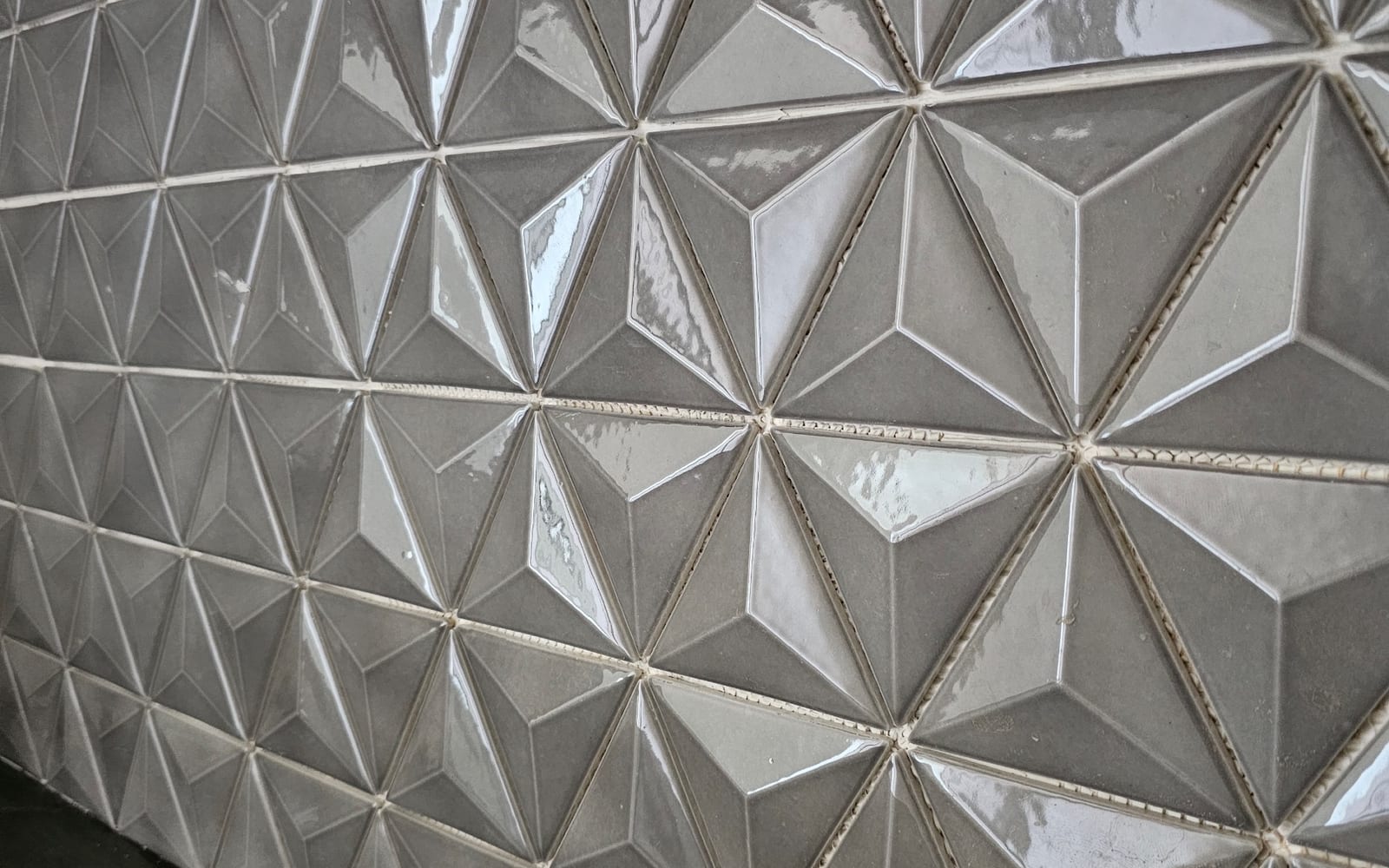 A close-up of a three-dimensional geometric tile feature wall set by Artemidas Renovation